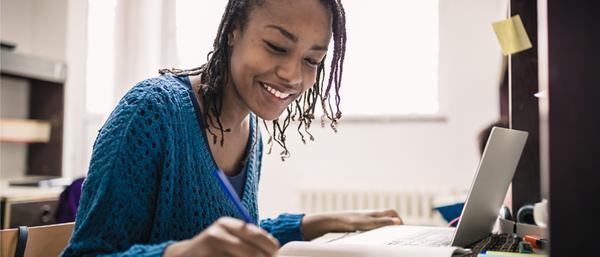 Woman looking over notes whilst smiling