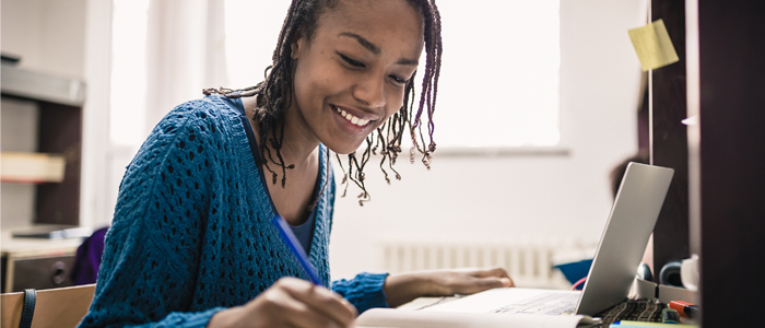 Woman looking over notes whilst smiling