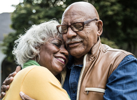 Older couple hugging and smiling